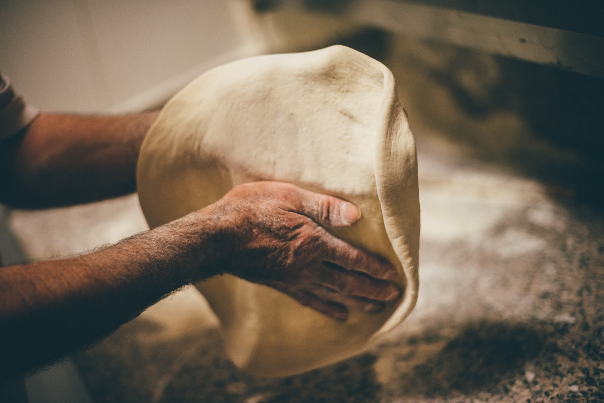 shaping pizza dough