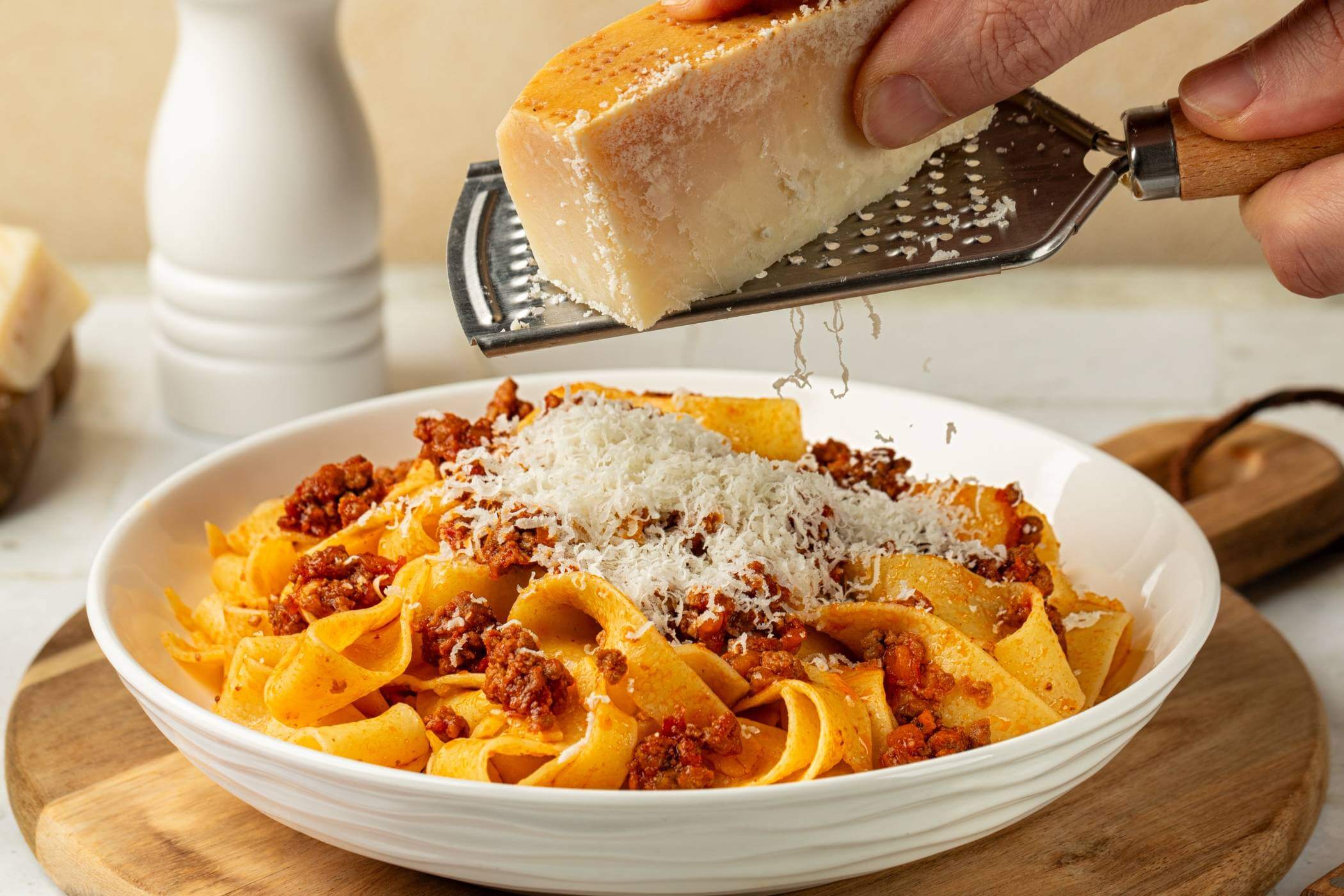 Grating cheese on pasta